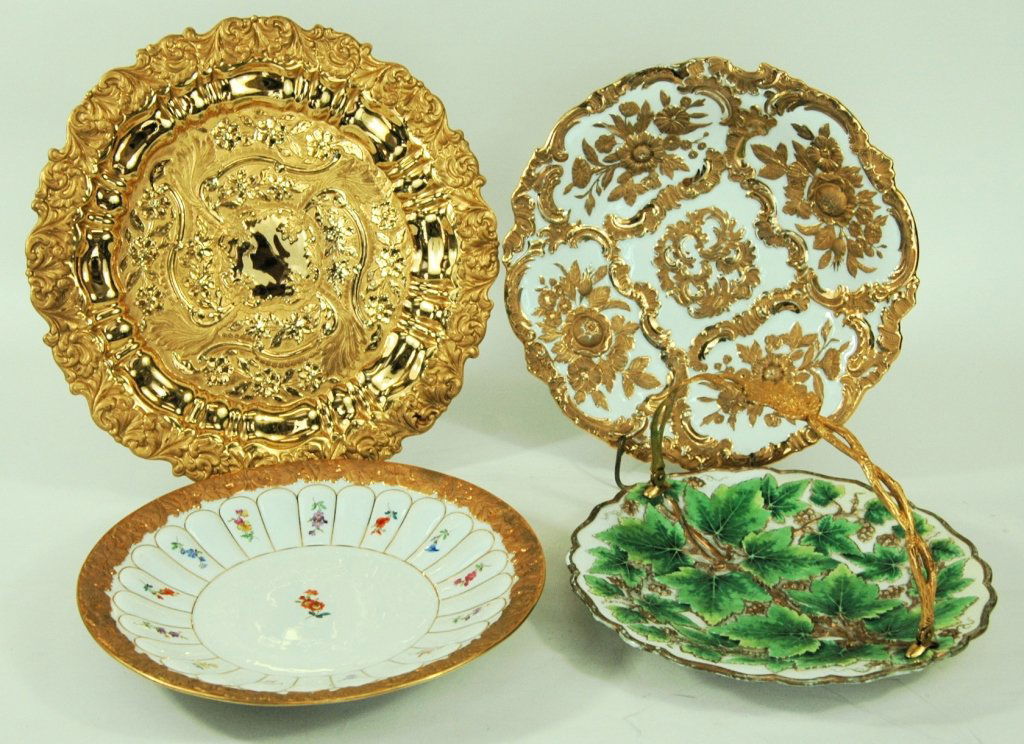 4 Meissen Serving Plates: Gold and white 11 dia. White with gold border 10.5 dia. Gold charger 12.5 dia. Ivy plate with handle 9.5 dia. All in good condition, some with wear. Blue cross sword under glaze mark.