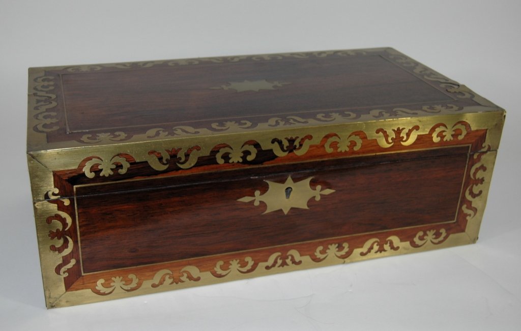 Fine Rosewood Lap Desk: with all over applied cut out brass ornamentation. Interior is very clean and intact with original purple velvet writing surface. Box measures 20 x 7 x 10.5. Great condition.