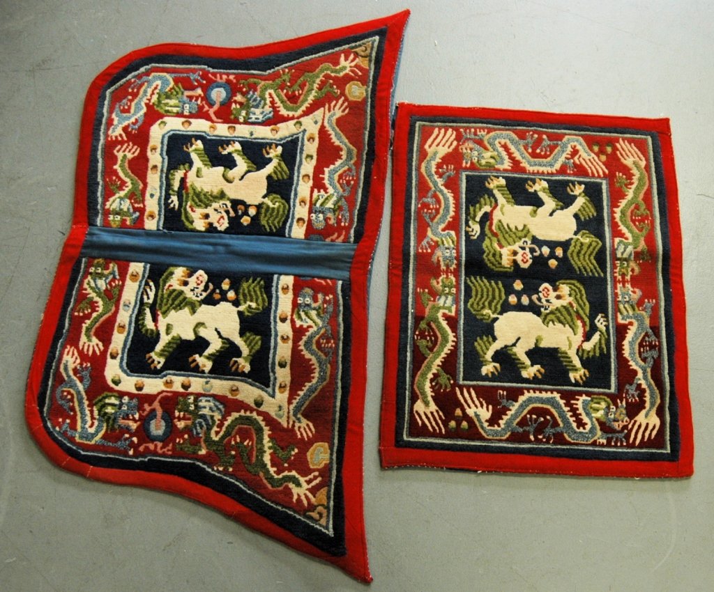 Nepalese Saddle Covers or Blankets: Nepalese saddle blankets or covers, hand knotted wool with Foo lion motif. Consignor personally rode on horses that used these in 1970. Good condition. Largest 51 x 25, small 33 x 26.
