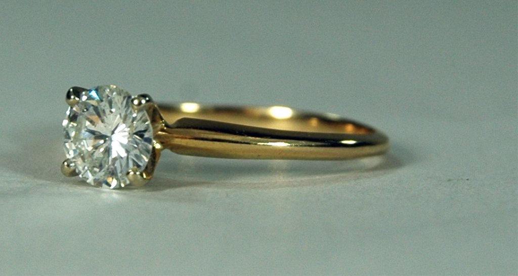 Diamond Solitaire Ring: Diamond solitaire ring, 1 carat diamond, I-1 clarity, I color, 57.71 depth, in 18K yellow gold, 2.67 grams of gold, 4 prong setting. GIA verbal assessment. Size 10.