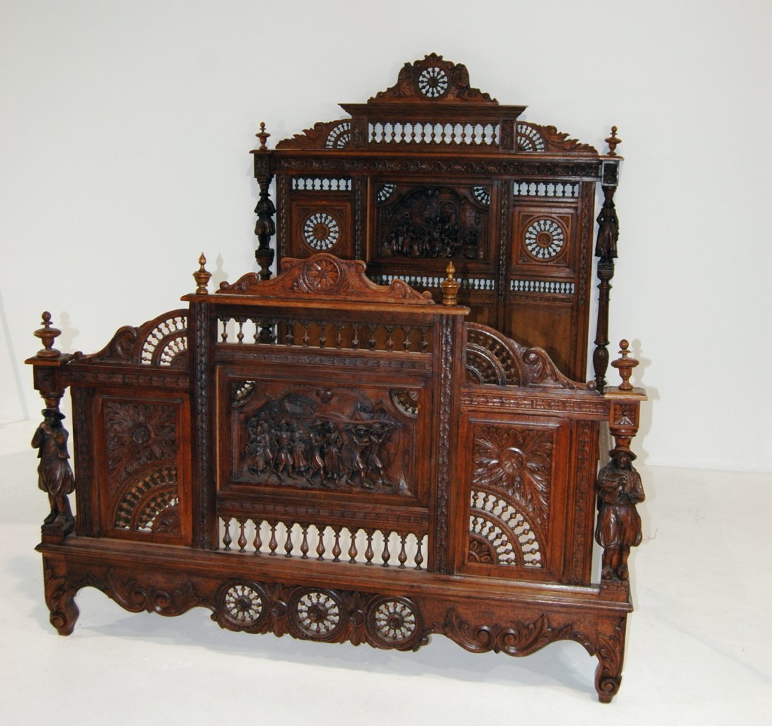 Carved Walnut Bed Frame: Intricately carved walnut bed with scenic panels in head and foot board, a multitude of turned spindles and finials, figural carved posts of male and female figures, great condition. 81 x 62.