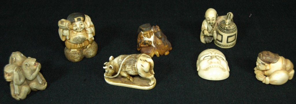 7 Carved Ivory Netsukes: 7 carved ivory Netsukes; 3 monkeys, man with gong, bovine, fat man with big shoes, sage with reindeer, kneeling man, smiling mask, all in good condition.NOTE: Ivory cannot be shipped internationally,