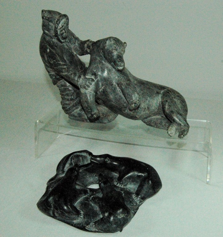 2 Inuit Folk Art Carvings: 2 Inuit folk art native stone carvings; one shows native dragging bear, the other a group of seals with their prey. Both in good condition, largest 8" x 12".