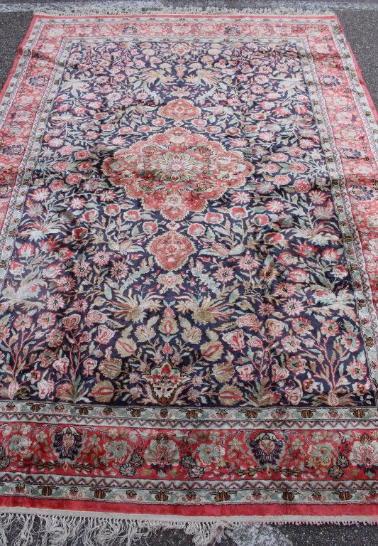 Silk Rug 9 x 6: Hand knotted silk area rug, Kerman, red and dark blue background, 9' x 6', very good condition, loss of some portion of fringe on one end.
