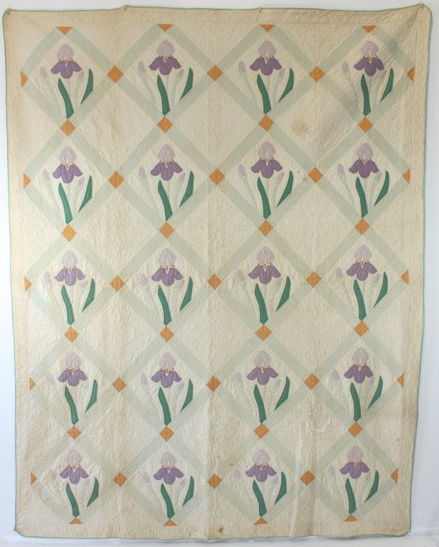 Early 20th Century "Iris" Quilt: Early 20th century "Iris" applique quilt, each flower in diamond shape quilted frame, some browning but fabric is in good shape. 75" x 97". From the Deborah Apple collection #921.