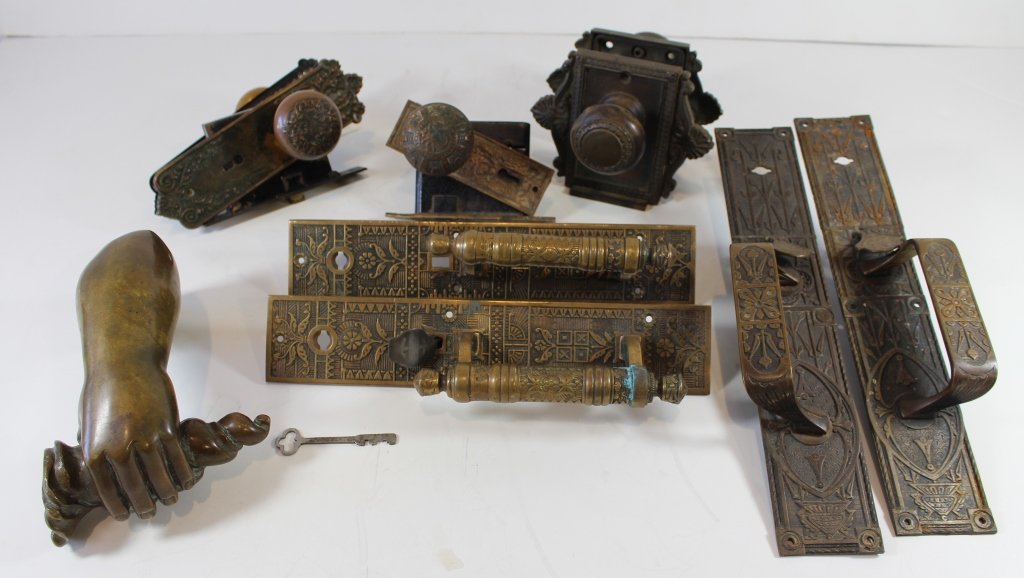 Group of Bronze Door Hardware: Group of late 19th century American bronze door hardware, back plates, handles, knobs and a most interesting hand door knocker, great patina on all.