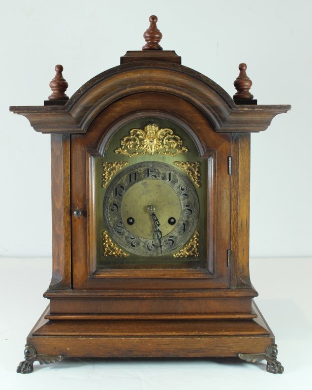 Unghans, German Bracket Clock: Unghans, German bracket clock, walnut case, brass clock face with ormolu, double chime strike, 18" x 14" x 8". Very good condition.