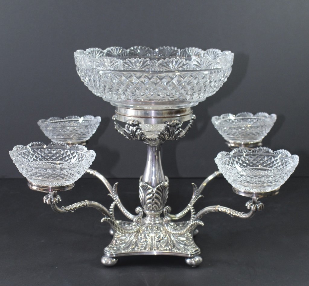 English Silverplate and Cut Glass Epergne: English silverplate 4 arm epergne with cut glass bowls. Very good condition with minor wear to the silverplate, c. 1890-1900.Note: tiny nick on one small bowl. Small rings 2.75" diameter, large 5" dia