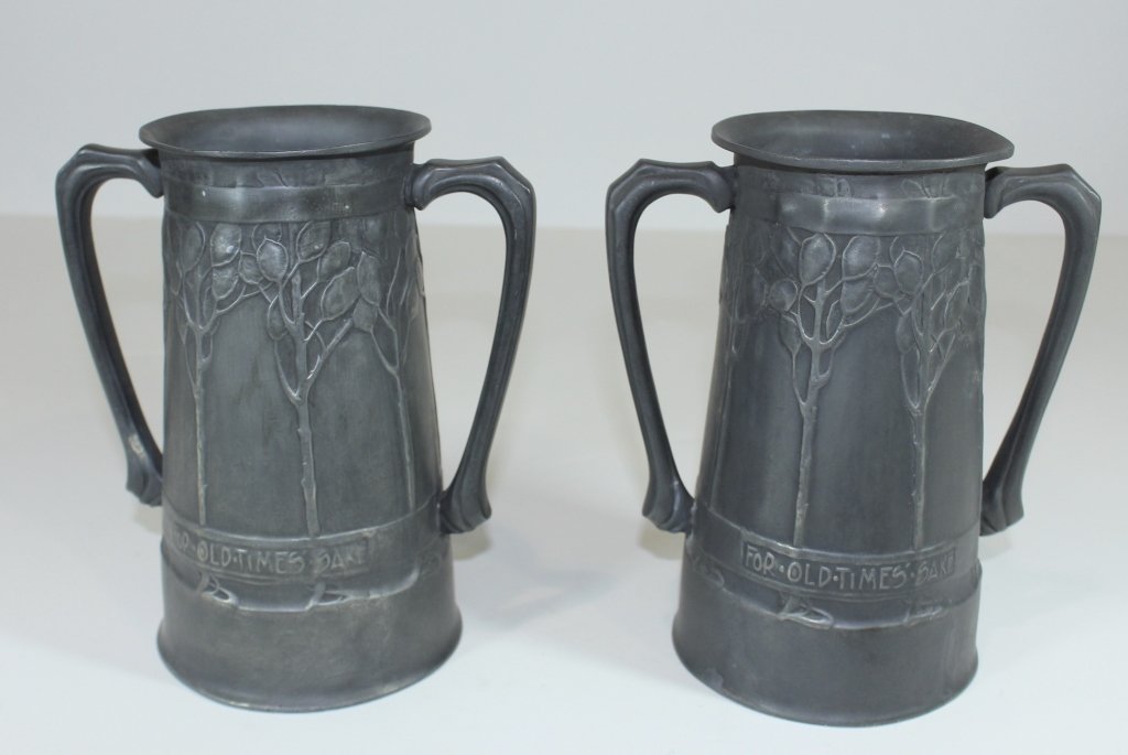 Two Liberty & Co. "Tudric" Pewter Vessels: Two Liberty & Co. "Tudric" pewter drinking vessels, stylized raised trees surround body with "For Old Times Sake" motto on each, 8", very good original condition, signed and numbered.