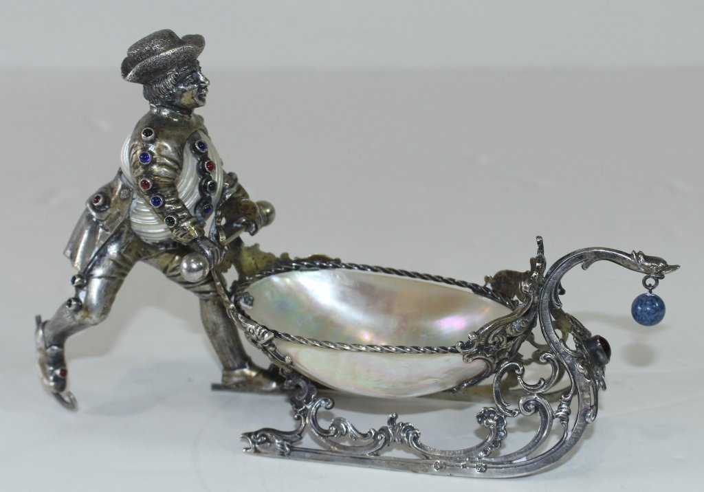 Important German Figural Sweetmeat: Important German silver (at least .800) figural sweetmeat server, man on ice skates pushing sled. Man's torso is mother of pearl nautilus shell, bowl of sled is mother of pearl shell. Man's clothes ar