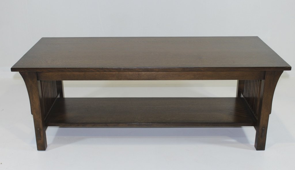 Stickley, Arts & Crafts Style Coffee Table: Stickley, Manilus, NY, oak Arts & Crafts style spindle side coffee table. Long corbels, through tenon construction and pegged joinery. Metal tag and burned-in signature, very good condition. 48" x 22"