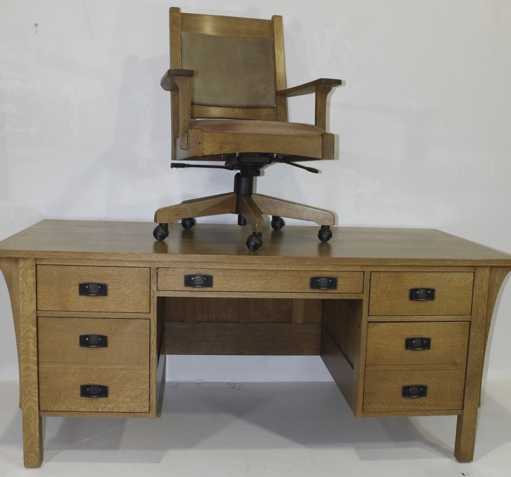 Stickley (new) Executive Desk & Chair: Stickley (new) Arts & Crafts style executive desk and swivel office chair in quarter sawn white oak. Desk has 3 drawers over 2 locking file drawers. Top has an area of scorching but repairable or forg