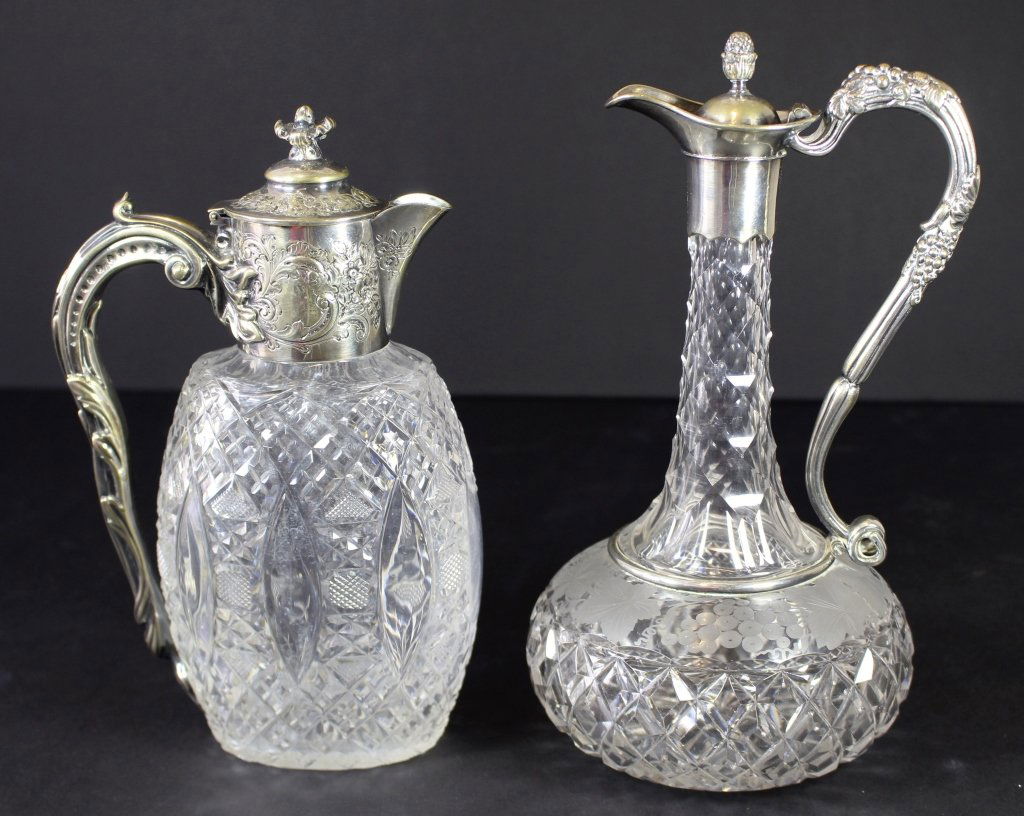 2 Cut Glass Wine Clarets: 2 cut glass wine clarets with fancy silverplate attachments. One with intaglio cut grapes, taller is 11.5", one is hallmarked, good condition.