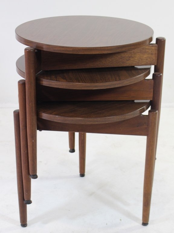 Jens Risom Design Inc Nesting Tables: Jens Risom Design Inc nesting occasional tables, walnut triangle base with wooden round legs, round laminate top in wood grain. Good condition, 17.5" x 18".