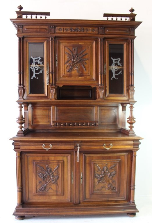 Carved Walnut Buffet, Late 1800s: Carved walnut buffet, late 1800s, wheat shaft bouquet carved on doors, etched glass doors on top section, nice cornice top, columns on middle serving surface with drawers and doors at bottom. Excellen