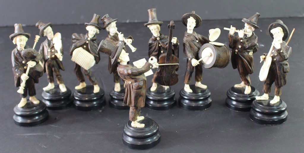 Group of 9 Black Forest Musicians: Group of nine carved wood and ivory black forest musicians. Whimsical 8 piece band with conductor. Tallest 7" all on turned ebony stands. Minor condition issues of 2 missing hat feathers, guitar strap