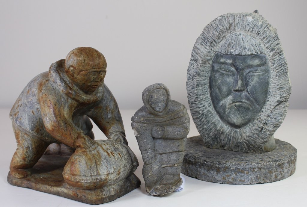 Three Inuit Stone Carvings: Three Inuit stone carvings; Eskimo rolling a bundle 8", 9", 5.5", signed "AJ E91255" on bottom, a bust of Native on round pedestal (not attached) 10", and crude carving of hunkered down walking Inuit 