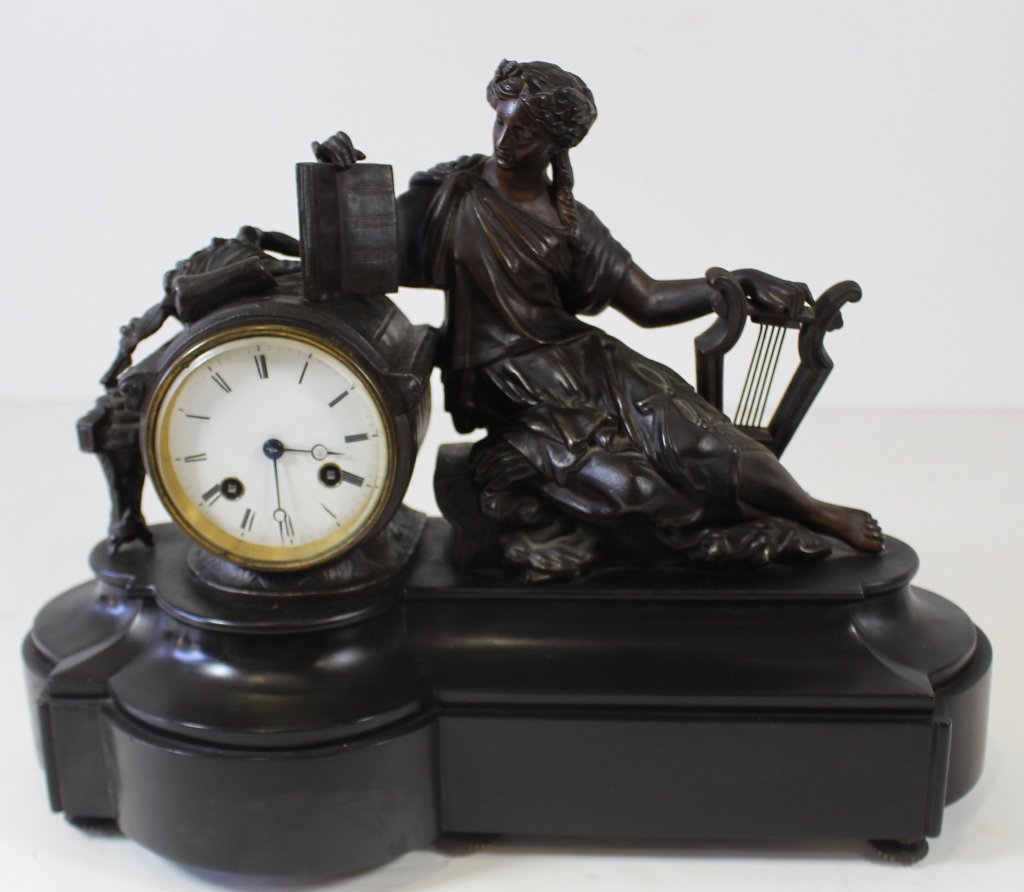 French Bronze Figural Mantle Clock: Fine French bronze figural mantle clock, black marble base, classic lady with lyre, porcelain face, no visible maker's mark, very good condition. 12" x 16" x 7".