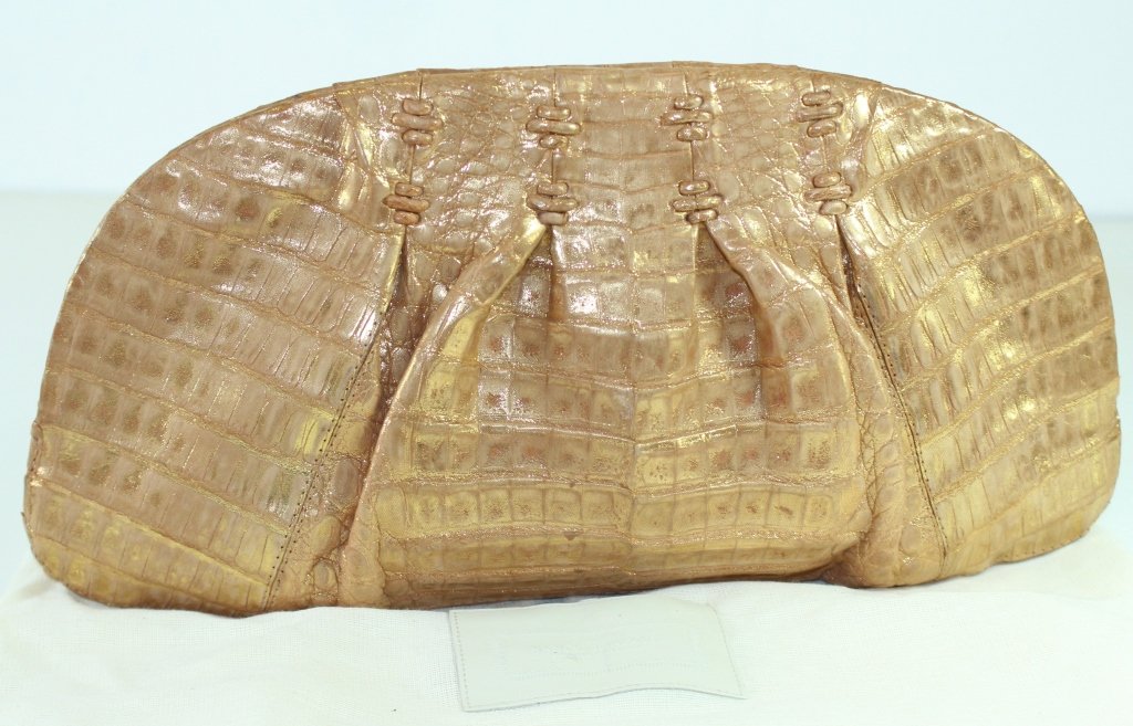 Nancy Gonzalez Gold Crocodile Clutch: Nancy Gonzalez gold tone genuine crocodile clutch, yellow suede interior, original price tag $1,641.00, gently used, 15" x 7.5" x 3", with original felt dust bag.
