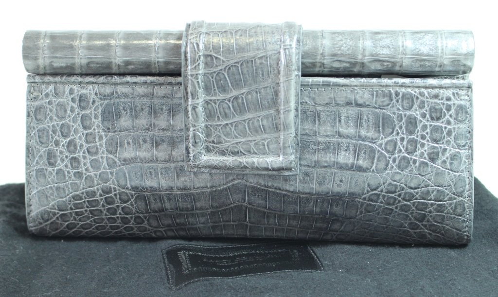 Nancy Gonzalez Gray Crocodile Clutch: Nancy Gonzalez gray crocodile clutch with magnetic closure, green suede interior, includes felt dust bag, gently used but like new, 9.75" x 5" x 2.5".