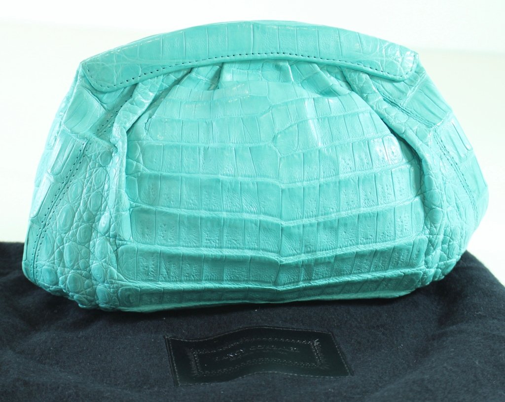 Nancy Gonzalez Turquoise Crocodile Clutch: Nancy Gonzalez turquoise crocodile clutch, magnetic closure, turquoise suede interior, shoulder strap inside, like new condition with original felt dust bag, 10" x 6" x 3.5". Gently used once.