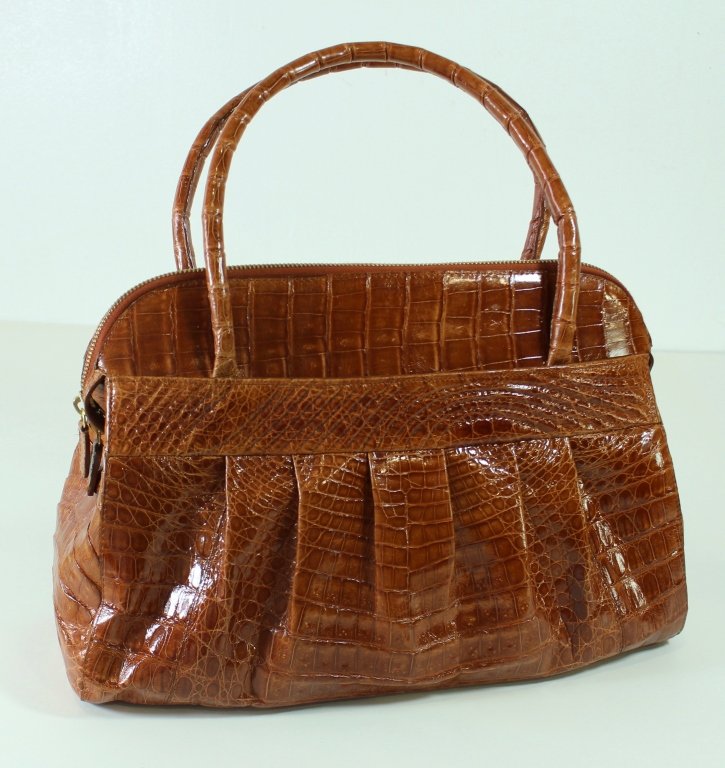 Nancy Gonzalez Coral Crocodile Handbag: Nancy Gonzalez coral crocodile handbag, zipper closure, outside pocket, matching interior suede lining, overall excellent condition, includes original dust bag. 14" x 15" x 5" with upright handles.