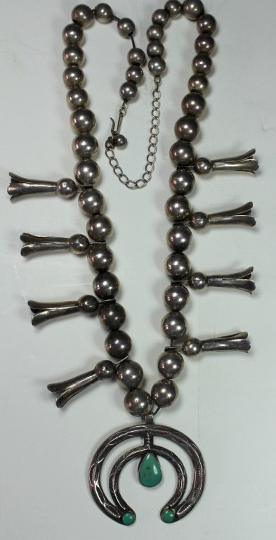 Native American Sterling Turquoise Necklace: Southwest Native American sterling and turquoise squash blossom necklace. Graduated beads, 8 blossoms, pendant, 22" chain, signed "Bell Trading Post", good condition.