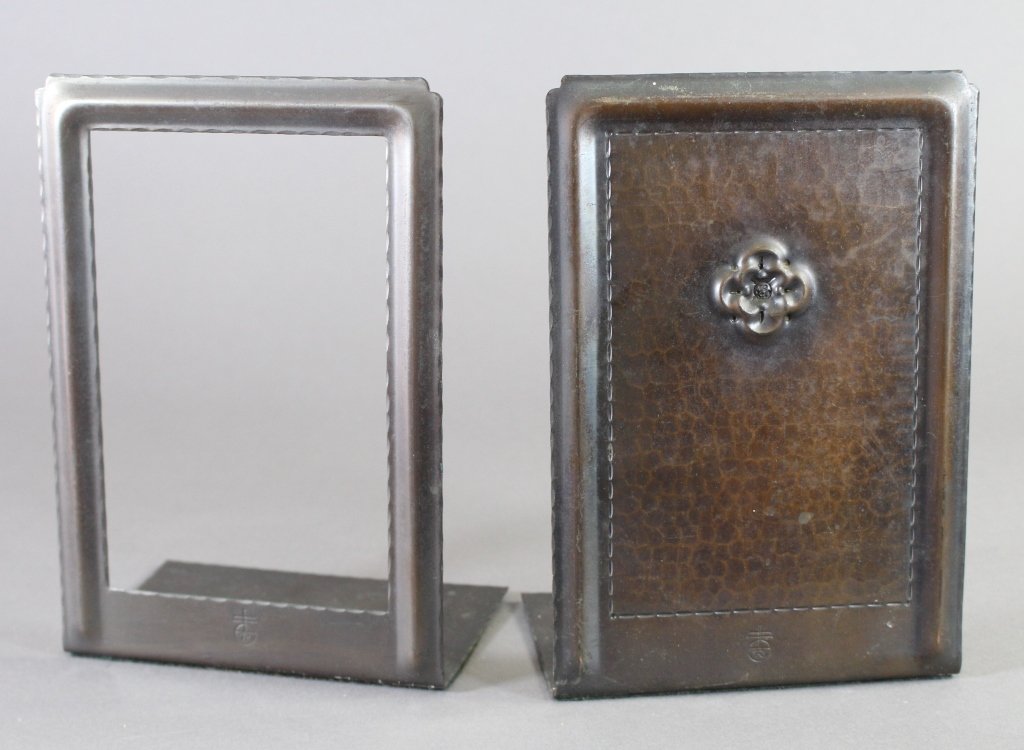 Roycroft Bookends: Roycroft bookends in hammered copper. One side open to display title of book, the other with highly embossed flower. Fine original patina with early orb mark. These were specifically made for use with