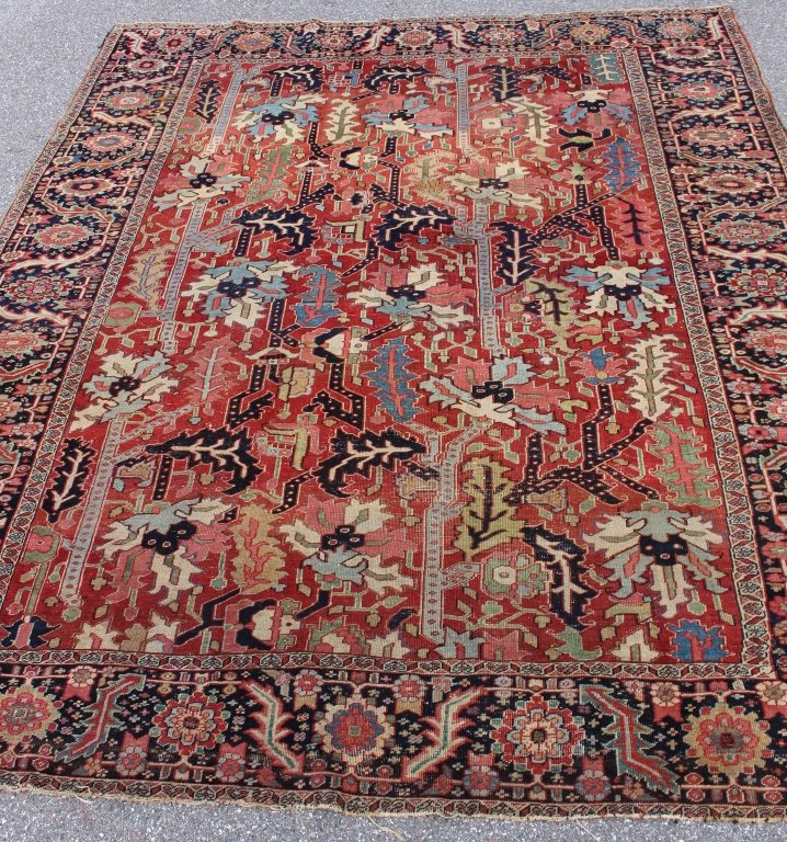 Antique Heriz Rug, 9.5' x 11.4': Antique Heriz area rug, c. 1900, 9.5' x 11.4', rust field, dark blue and black border, all over angular floral design, very minor moth damage at one end, minor brown stain in border, overall good cond