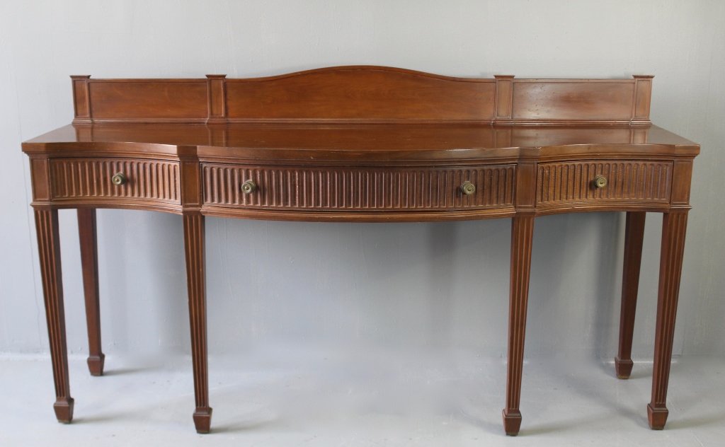 English Mahogany Sideboard: English mahogany sideboard, serpentine front with 3 drawers, 6 reeded column legs ending in spade foot, humpback splashback, c. 1880, very good condition, 43" tall, 78" wide, 23" deep.