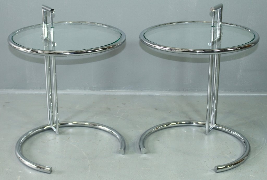 Pair of Polished Chrome & Glass Tables: Pair of polished chrome & glass adjustable tables in the style of Eileen Gray, 25.5" height shown, 20" diameter, excellent condition.