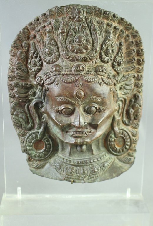 Nepalese 16th Century Copper Mask: Nepalese 16th century copper repousse mask of Charmundi, with custom Lucite stand. 7.5" x 5.5", good condition.