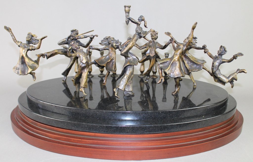 Zachary Oxman, b. 1968, Bronze: Zachary Oxman, born 1968, bronze figural menorah on black marble and wood plinth. Ten dancers and musicians having a really good time with 8 candleholders on backside edge, limited edition 61/1000, si