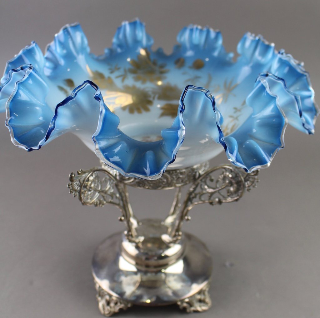 Victorian Blue Ruffled Bride's Basket: Victorian blue cased glass, ruffled bride's basket on silver plate stand, signed with "W" in spider web, bowl is blue ruffled with interior gold stenciling and portrait of young couple. Bowl 4.5" x 12