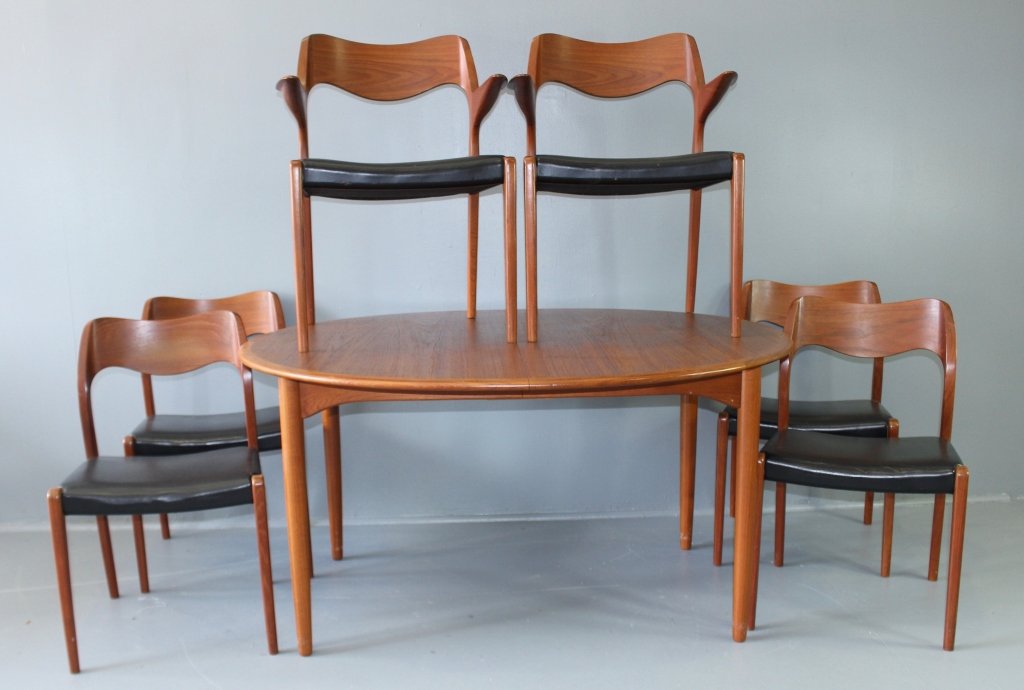 Mid Century Modern Dining Table & Chairs: Mid century Danish modern dining room table and 8 chairs. Solid teak, oval 55" x 47" table top, 2-23.5" leaves, chairs have original black leather seats, 2-32" x 23" x 18" armchairs, 6-30" x 18" x 17"