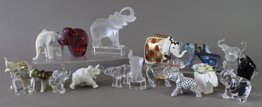 Collection of Figural Elephants: Collection of 19 figural elephants: Lalique, Royal Crown Derby, Herend, Baccarat, Fenton, Royal Dux, Waterford, Nachtmann, Royal Copenhagen, Royal Doulton, Lenox, Goebel, Wedgwood, and others. All min