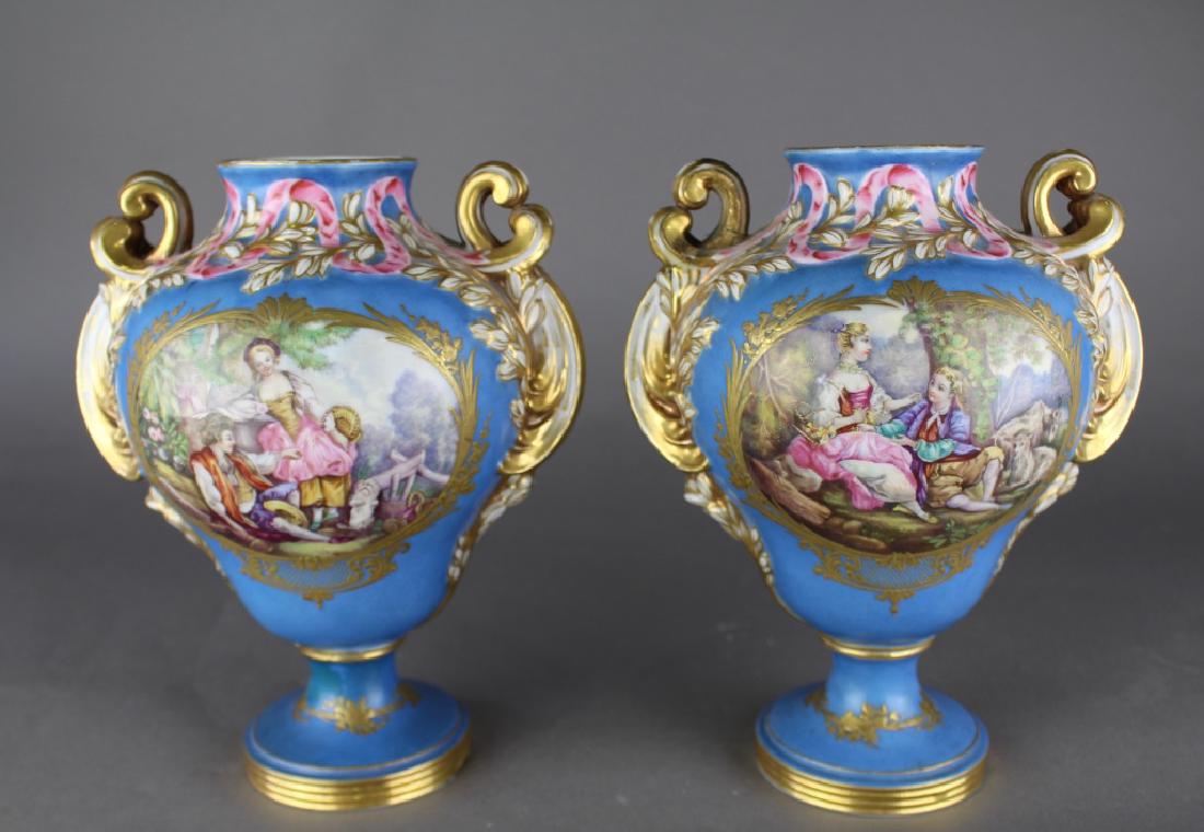 Pair Jacob Petit French Porcelain Vases: Pair Jacob Petit French porcelain vases, both signed, floral decoration on one side, scenic on other, one has minor blemish at rim and repaired handle (shown) 9" x 7", mid 1800s, Fountainbleau, France