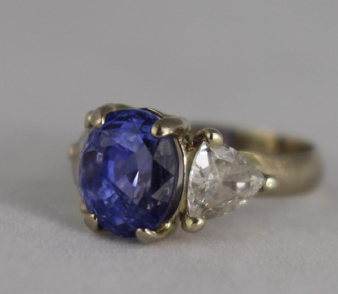 Lady's 5 Carat Sapphire and Diamond Ring: Lady's 5 carat sapphire and diamond ring set in 14K white gold, 2-.5 trillion cut diamond on each side, 3.5 ring size. Fine condition.
