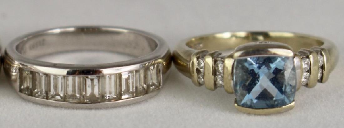 Two Lady's Platinum and Gold Rings: Two lady's fashion rings: Platinum band with 9 baguette cut channel set diamonds signed KWIAT, size 5 and a 14K white gold princess cut aquamarine approximately 3 carats with 8 round cut diamonds chan