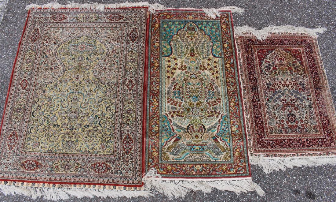 Three Persian 100% Silk Rugs: Three Persian 100% silk hand knotted prayer rugs, 52" x 37", example, maker signed, 8 borders (red) with gold thread floral central field. 49" x 25" with birds in border then 2 birds predominant in bu
