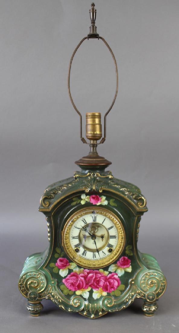 Royal Bonn Porcelain Clock with Ansonia Works: Extremely rare Royal Bonn porcelain clock with Ansonia clock works with light fixture on top. Case name in raised letters on back "La Flandre", red ink mark as well as an impressed mark and #2989, ver