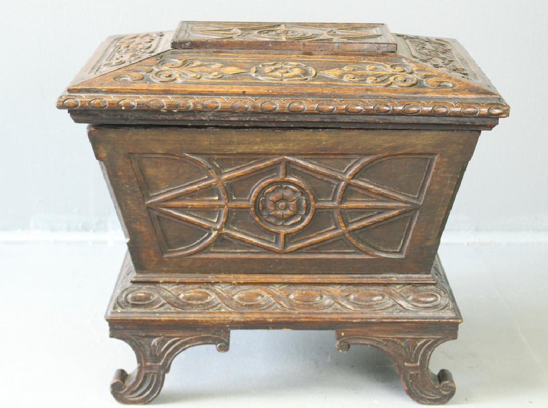 Carved English Oak Cellarette: Carved English oak cellarette, richly carved all over with pyramidal top, original metal liner, c. 1870, very good condition, 21"h, 24"w, 19"d.