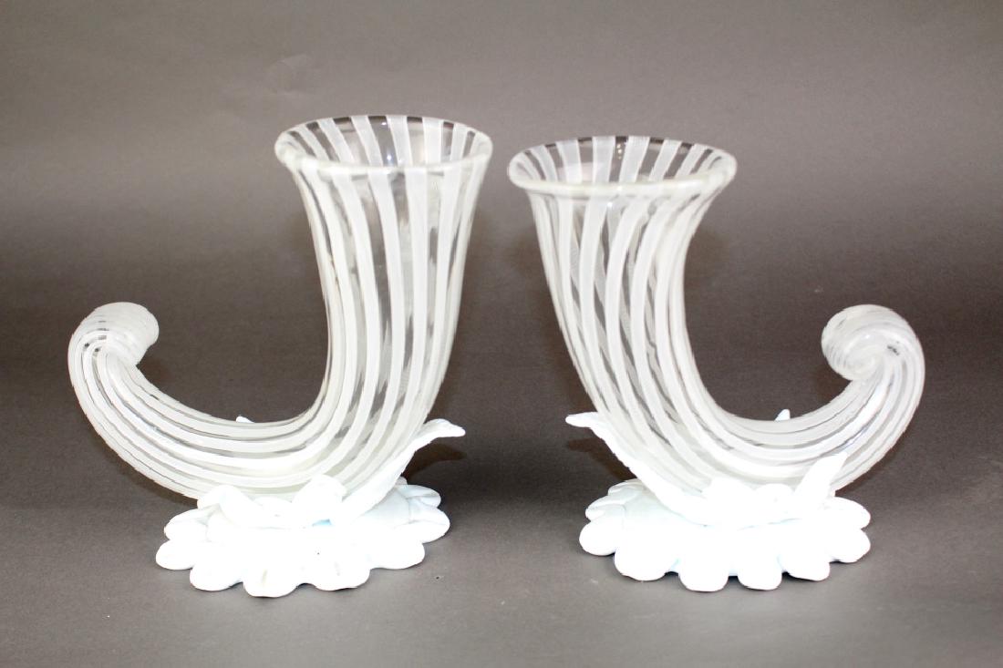 Pair of "Venini Italy" Murano Vases: Pair of signed Venini Italy Murano cornucopia vases, Latticino stripes on clear body with applied white glass base and attached leaves, 8" x 8", good condition. Note: they are signed Venini Italia