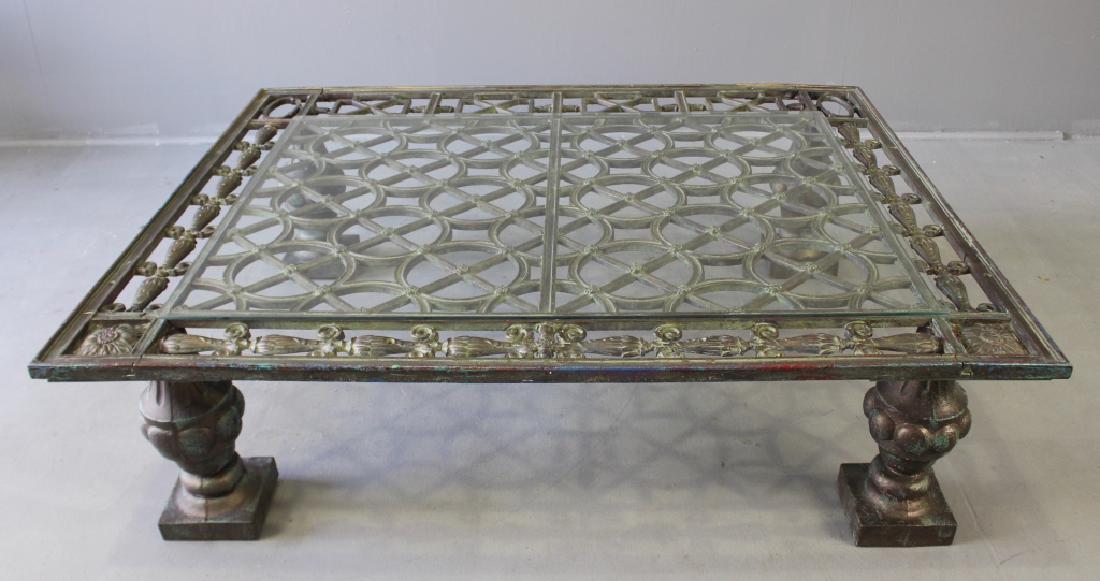 1800s Cast Iron Gate Philadelphia: Unique cast iron coffee table re-purposed from late 1800s gate from estate in Philadelphia, 4 welded posts for legs, fine openwork with sized 44" x 38" glass top. 15.5"h, 54.5"w, 46"d. Heavy 200 pound