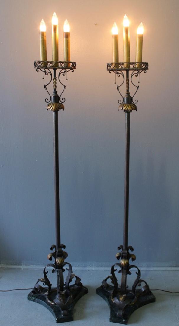 Pair of Wrought Iron Torchere Lamps: Pair of early 20th century fancy wrought iron triple light torchere lamps, each with 3 pull chain sockets, gold highlights on metal work, each on heavy dark green marble base, 68" tall, 17" diameter b