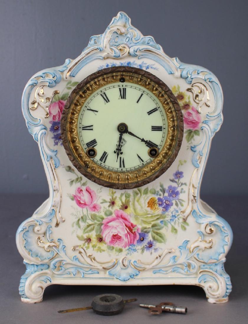 Royal Bonn Porcelain Clock "La Clair": Royal Bonn porcelain clock case "La Clair" with Ansonia clock works, c. 1890, 8-day time and strike movement, light blue case with floras, normal wear to case, no chips or hairlines, 13" x 10" x 5.5",