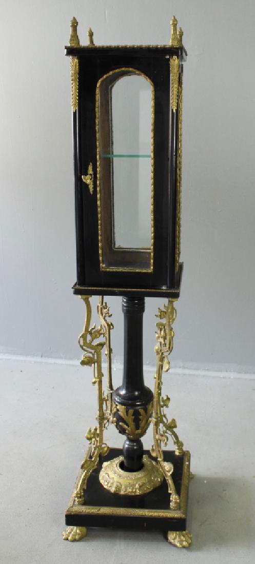 Devotional Vitrine: Devotional vitrine in dark hardwood, brass ormolu and glass, locking door. Pedestal appears to have been repaired. 55" x 16" x 16", good condition.