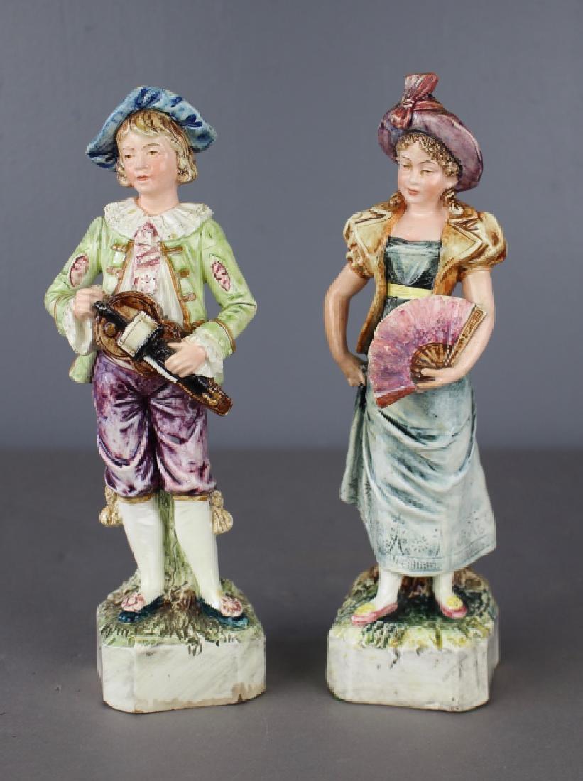 Pair of European Majolica Figurines: Pair of European Majolica figurines, young man with violin, young girl with fan, 11", good condition, unmarked.