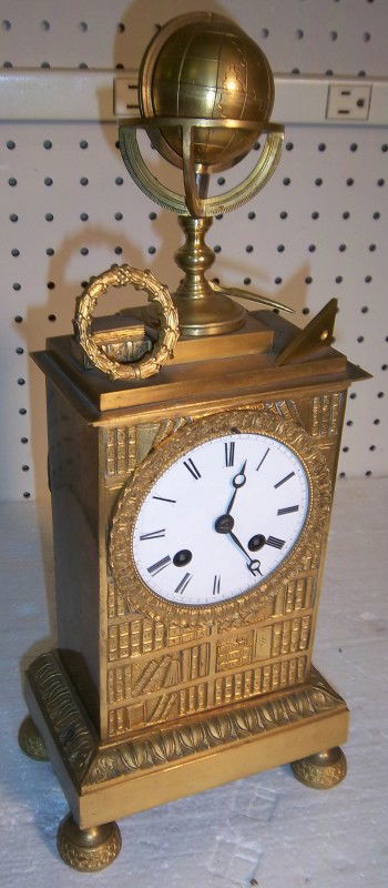 C1820 Dore Bronze French Empire mantle clock: C1820 Dore Bronze diminative French Empire mantle clock with mechanical world globe 15"h Auction Estimate 900-1800