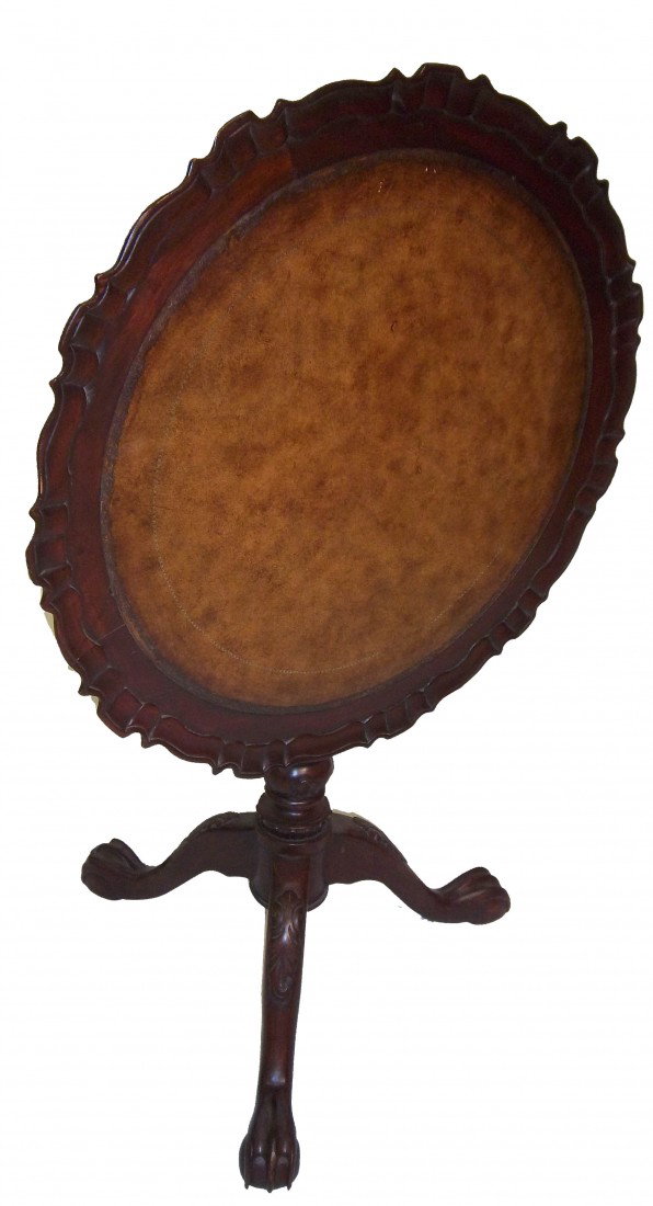 Maitland Smith mahogany tilt top pie crust table: Early 20th C. Maitland Smith carved mahogany tilt top pie crust table with original leather tooled top 29"hx28"diam. Auction Estimate $300-600